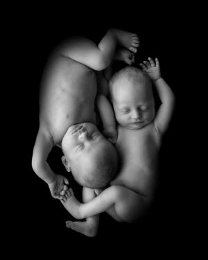 Newborn baby twins posed on soft black jersey backdrop Molly during a photo session