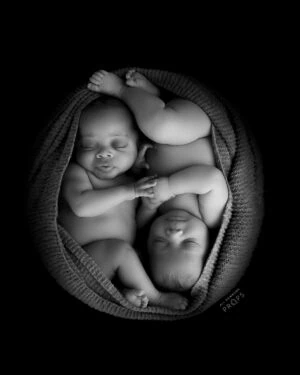 Newborn boy twins photographed on white posing fabric Molly during a studio session