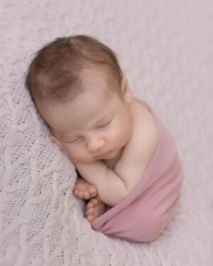 Baby girl wrapped in the Molly rose pink swaddle during a newborn photography session