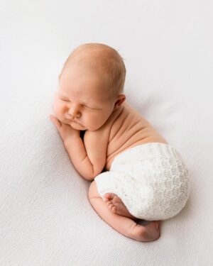 Back view of baby boy in cream Weston newborn bloomers captured during a photography session.