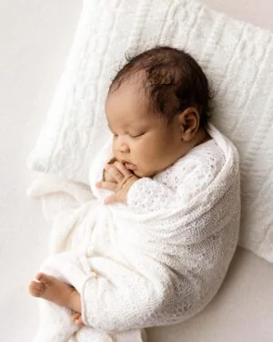 Coordinated newborn photo prop set featuring Yona romper in cream