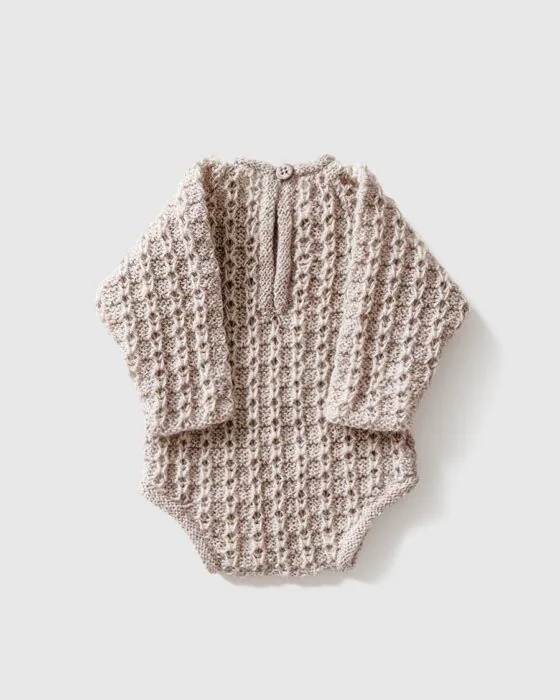 Back view of newborn romper with button closure – flat lay style