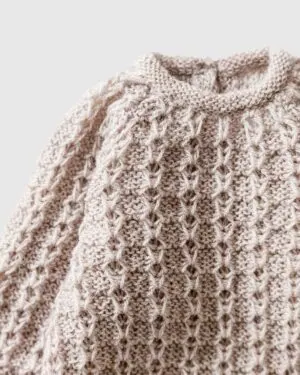 Close-up of stitch detail on Yona newborn romper in linen