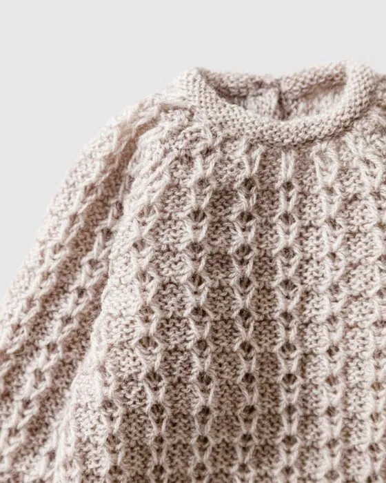 Close-up of stitch detail on Yona newborn romper in linen