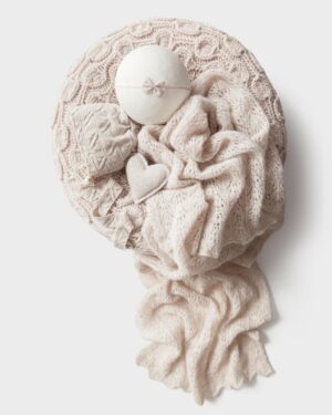 Coordinated newborn photography props in warm oatmeal tones – includes knit wrap, bonnet, poser, headband, and felted heart arranged together